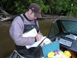 Man recording data in boat